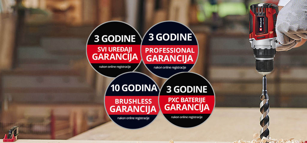 Ovde možete videti čoveka u radionici sa Ajnhel bušilicom u upotrebi. Pored toga, na slici su postavljene ikone za različite vrste produženja garancije. Moguća su sledeća produženja garancije: „Svi uredaji “, „Professional garancija“, „Brushless Garancija“, „PXC Baterije“.